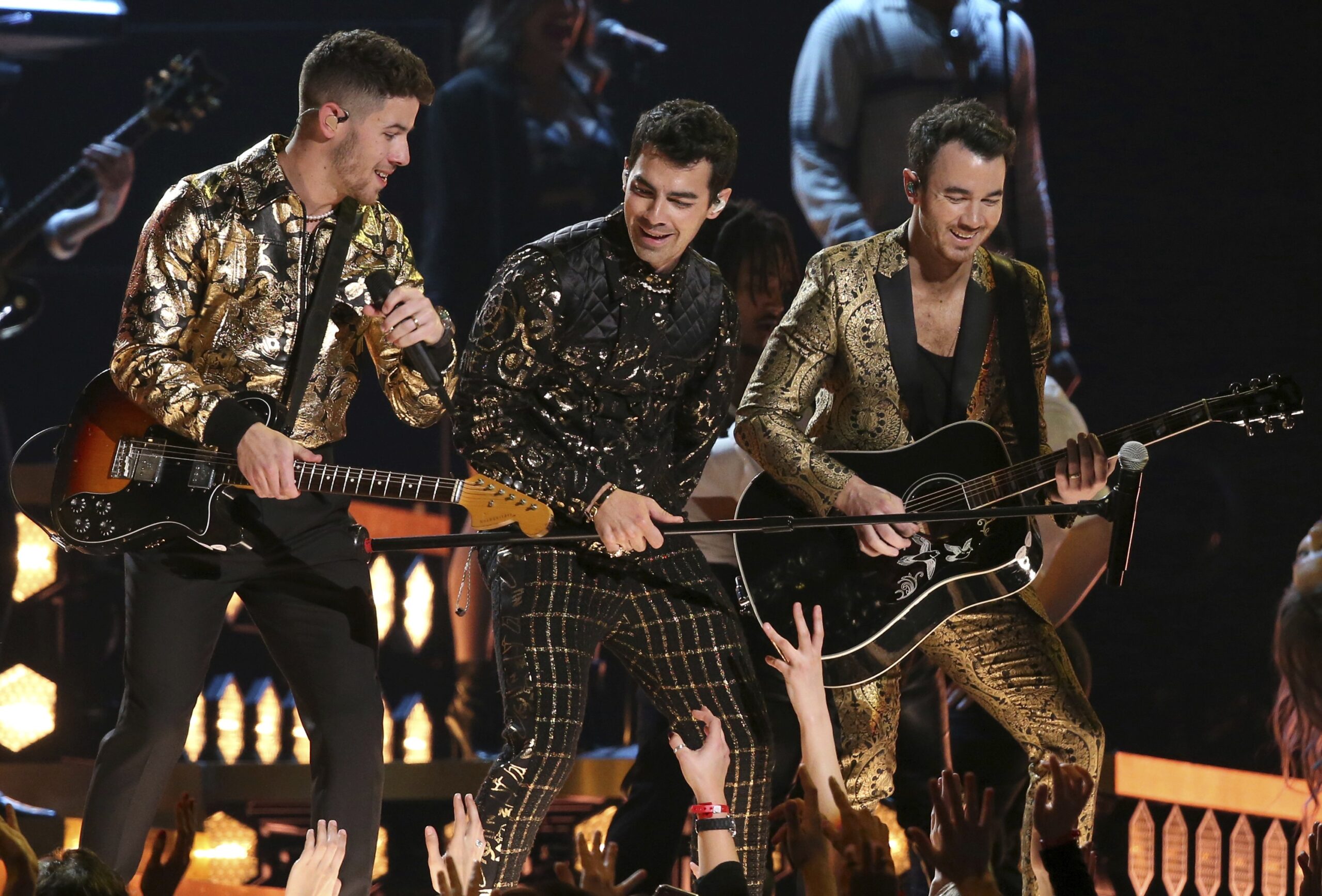 Jonas Brothers performing on tour